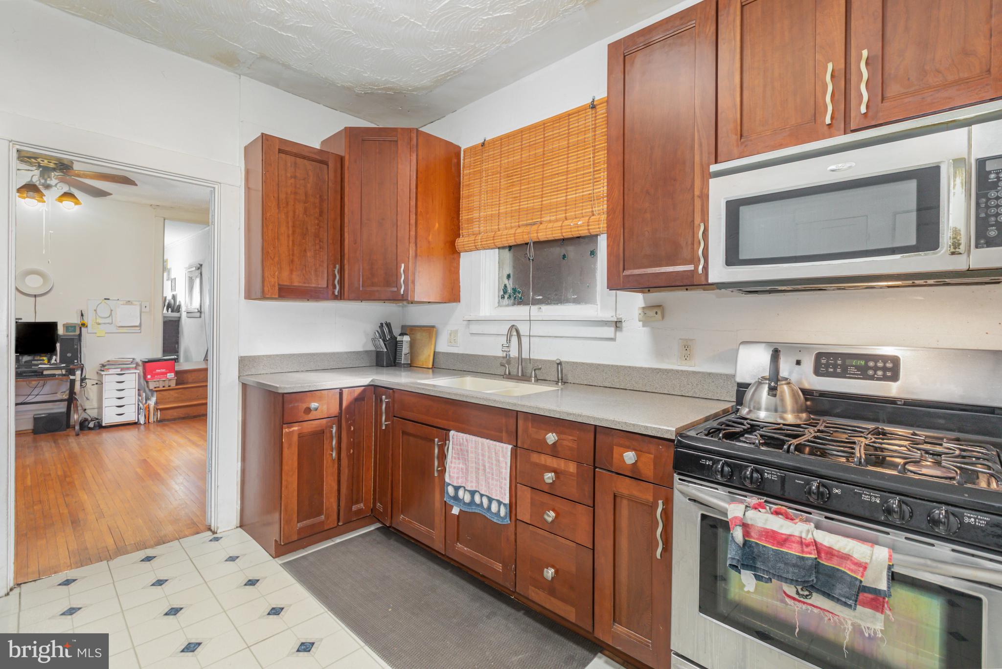 1204 North 16th Street Harrisburg, PA 17103 - Photo 12 of 30 a kitchen with stainless steel appliances granite countertop a stove and a microwave