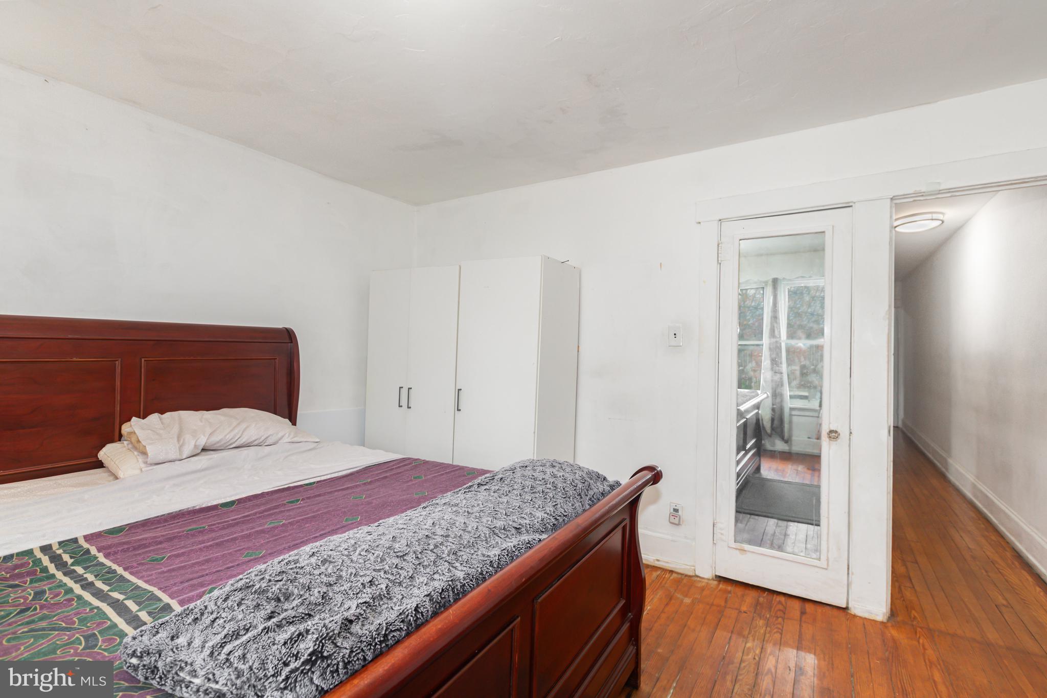 1204 North 16th Street Harrisburg, PA 17103 - Photo 14 of 30 a bedroom with a large bed and wooden floor