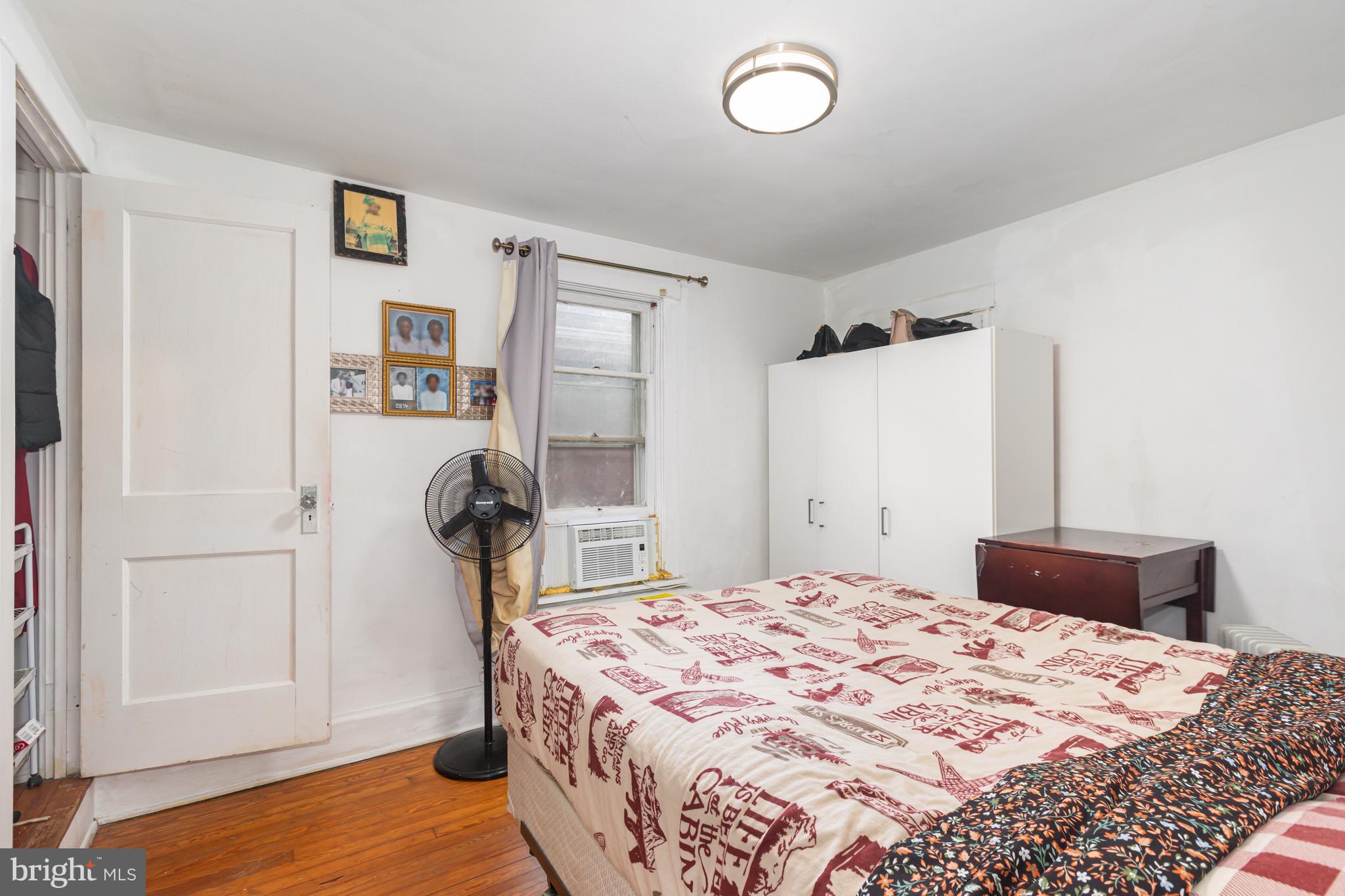 1204 North 16th Street Harrisburg, PA 17103 - Photo 15 of 30 a bedroom with a bed and wooden floor