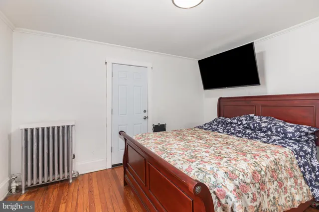 a bedroom with a bed and flat screen tv