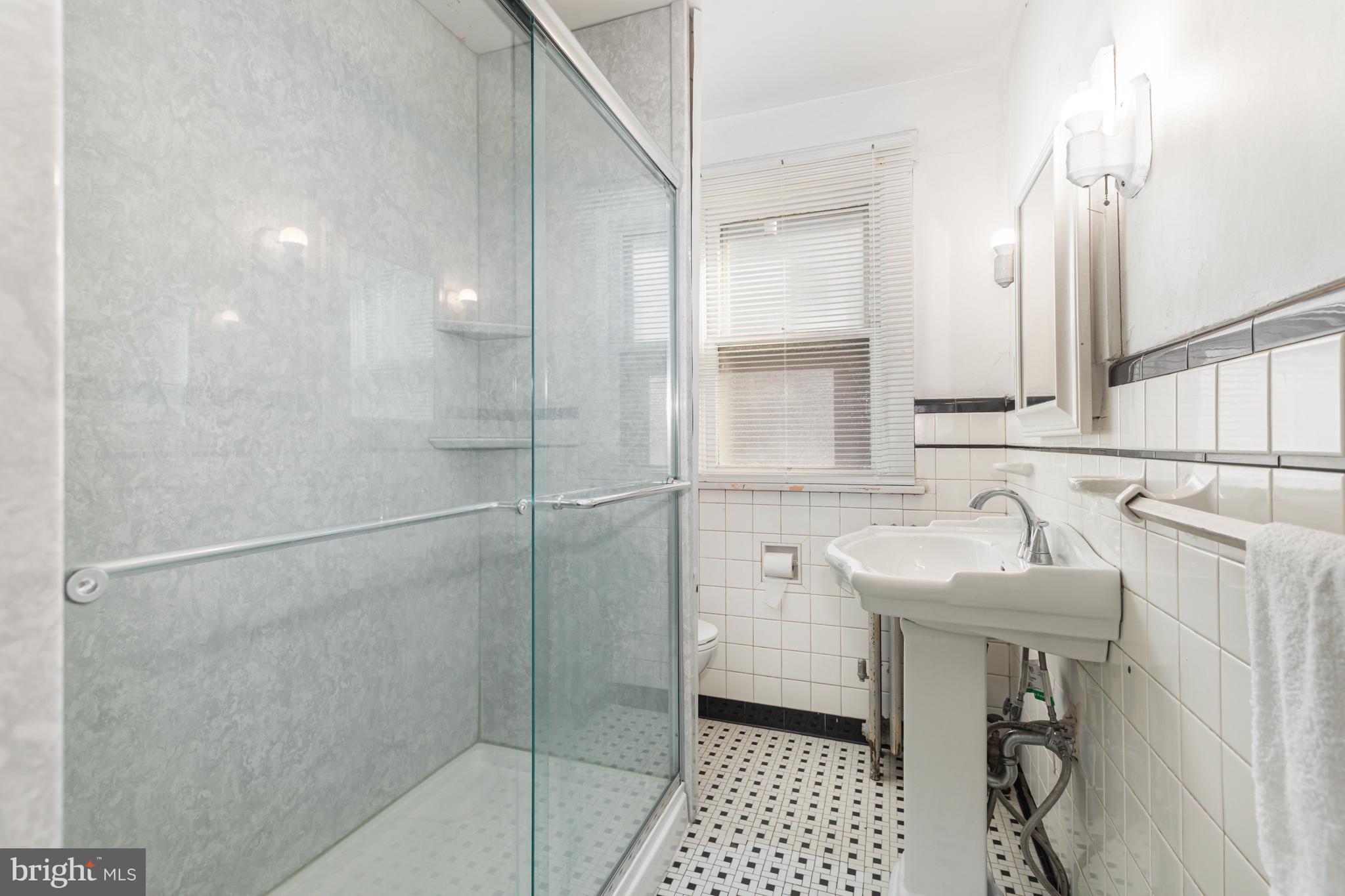 1204 North 16th Street Harrisburg, PA 17103 - Photo 19 of 30 a bathroom with a sink and a mirror