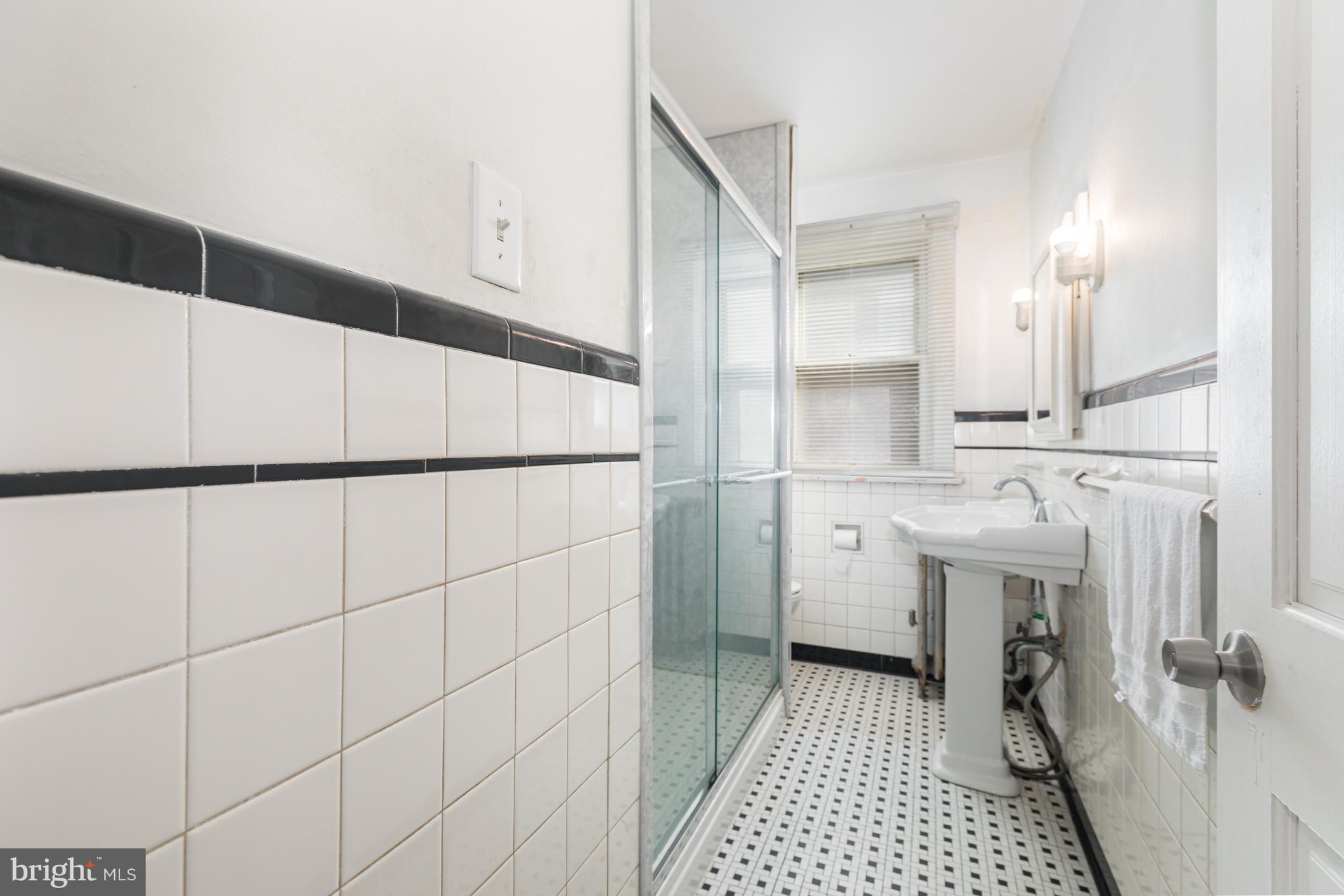 1204 North 16th Street Harrisburg, PA 17103 - Photo 20 of 30 a bathroom with a sink a toilet and shower