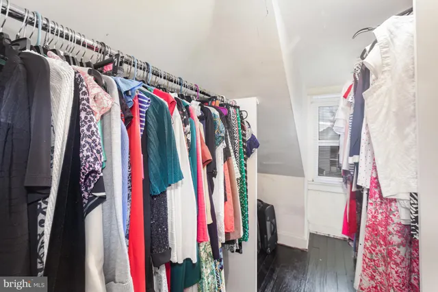 a view of walk in closet with clothes