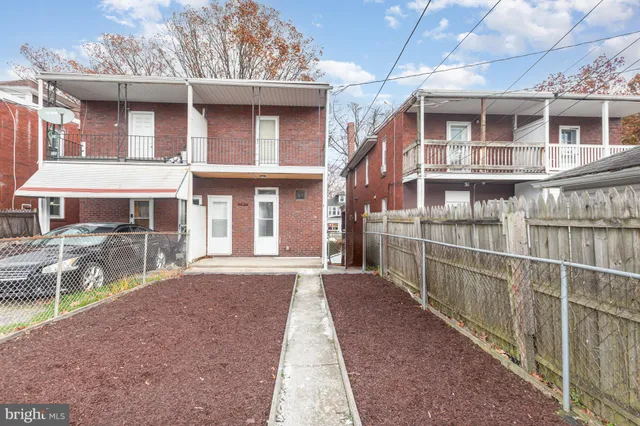 a view of a brick building next to a yard