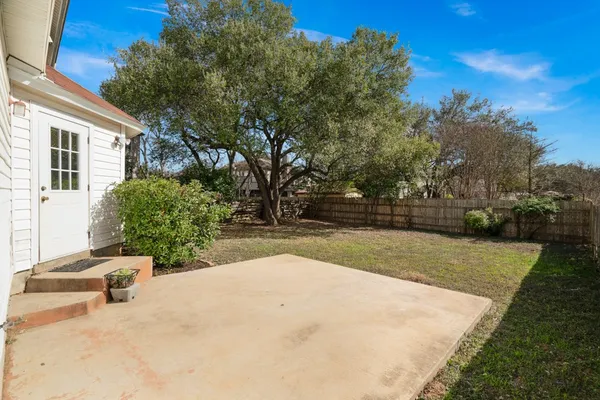 a view of backyard with swimming pool