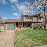 a front view of a house with a yard table and chairs