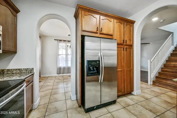 a kitchen with stainless steel appliances granite countertop a sink and cabinets