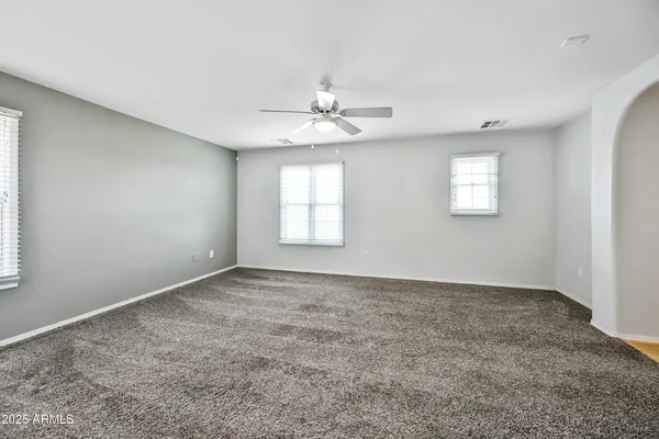 an empty room with windows and closet