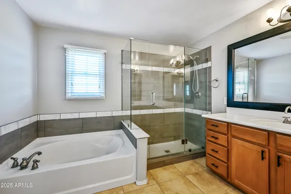 a bathroom with a double vanity sink and a mirror