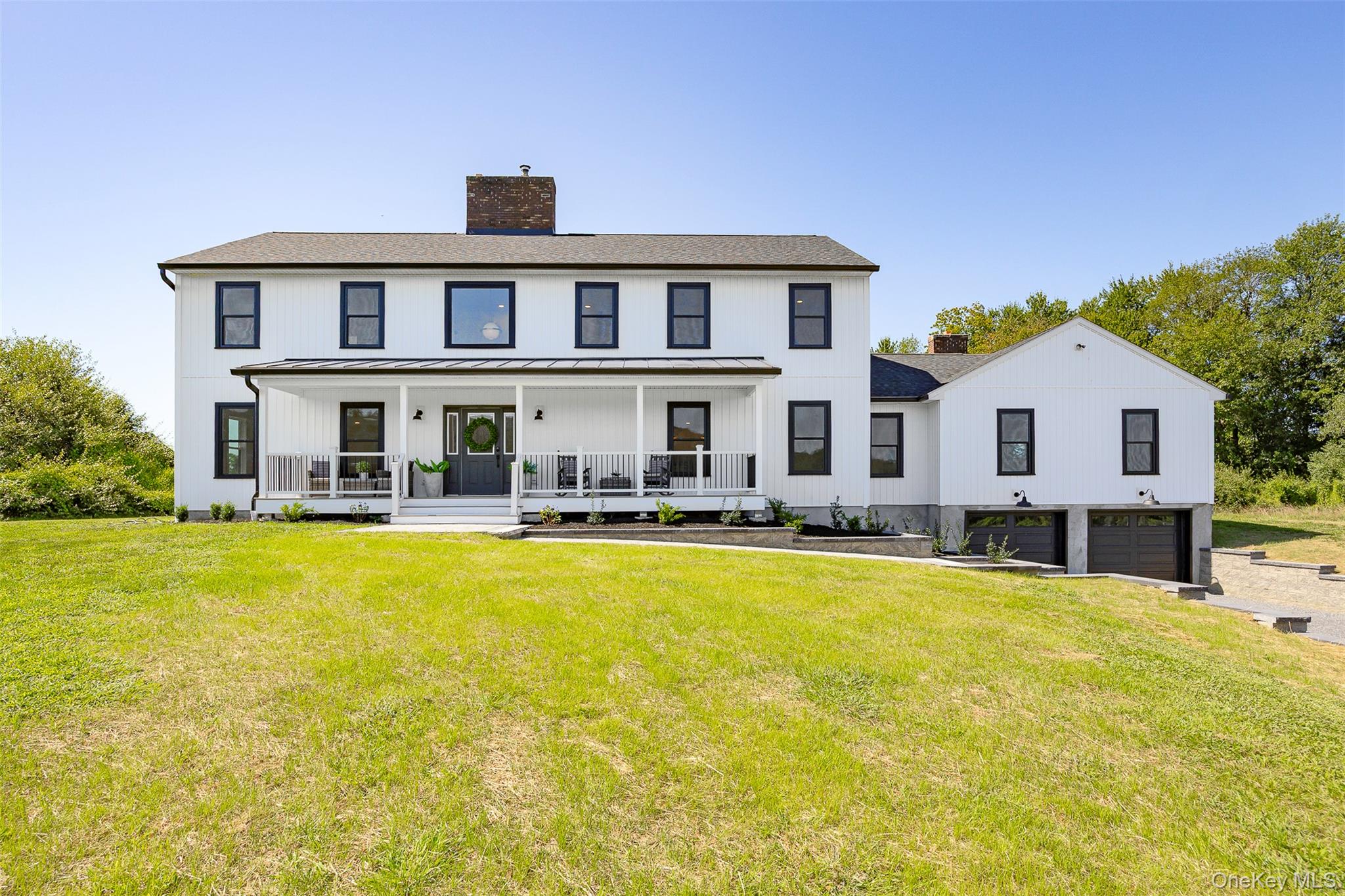 327 Hynes Road Poughquag, NY 12570 - Photo 1 of 39 Front view of house featuring covered porch, a chimney, an attached garage, and a yard