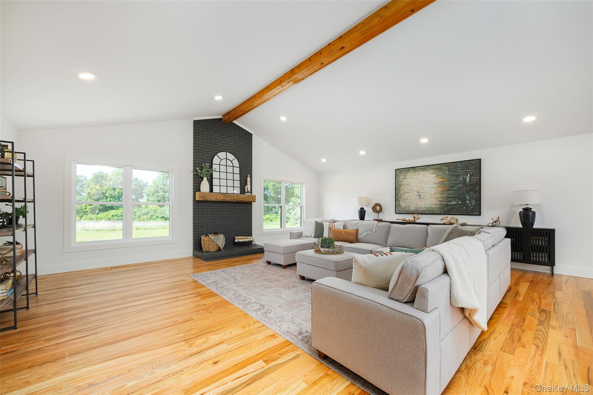 327 Hynes Road Poughquag, NY 12570 - Photo 13 of 39 Living area featuring beamed ceiling, recessed lighting, light wood-style flooring, a brick fireplace, and high vaulted ceiling