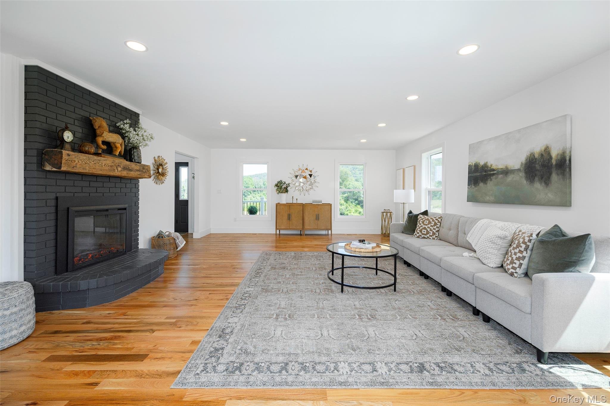 327 Hynes Road Poughquag, NY 12570 - Photo 7 of 39 Living area featuring light wood-style flooring, a brick fireplace, and recessed lighting