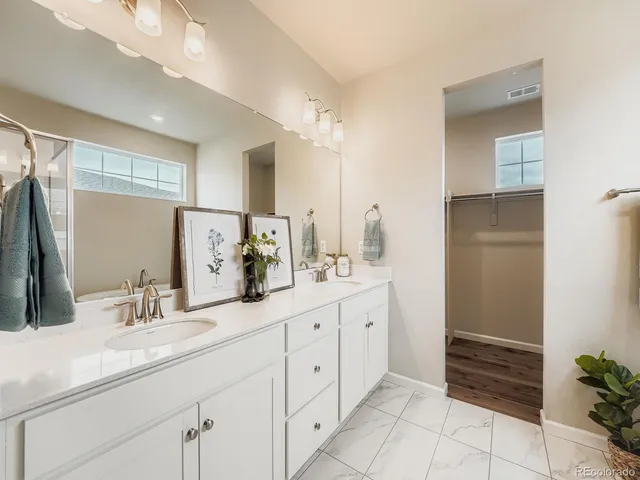 a bathroom with a double vanity sink and a mirror