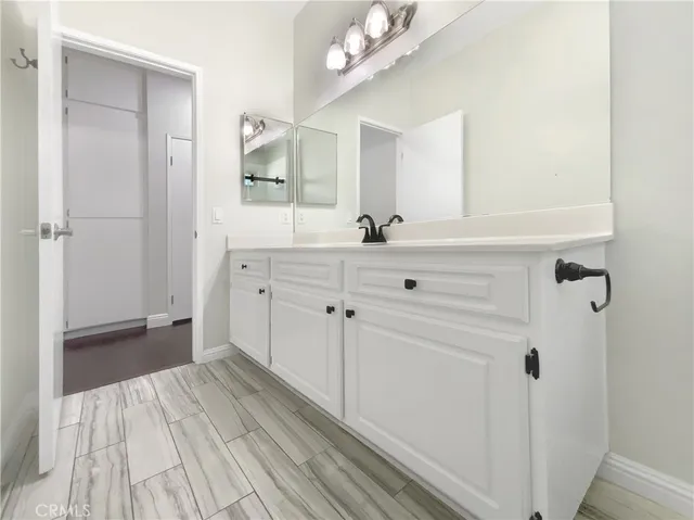 a spacious bathroom with a sink a toilet a mirror and shower