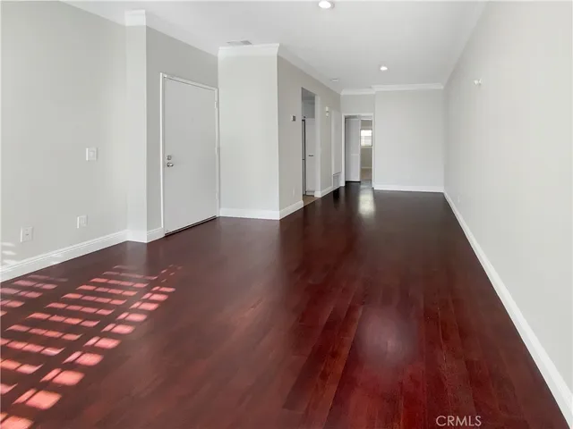 an entryway in a hall with wooden floor