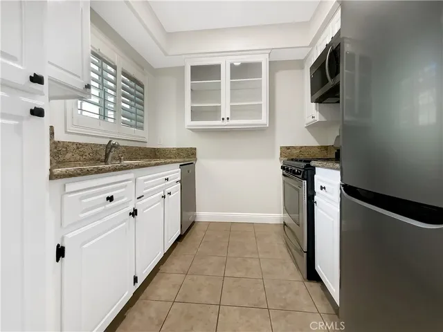 a kitchen with a refrigerator stove and microwave