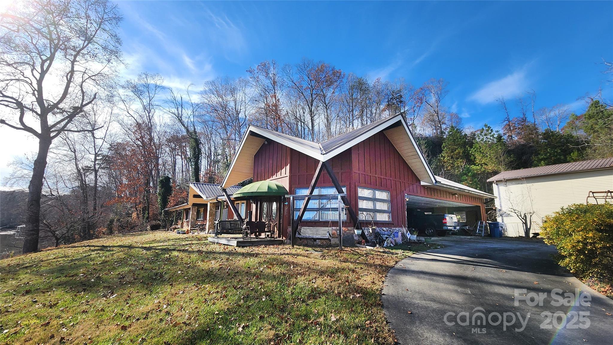 a view of a house with a yard and tree s