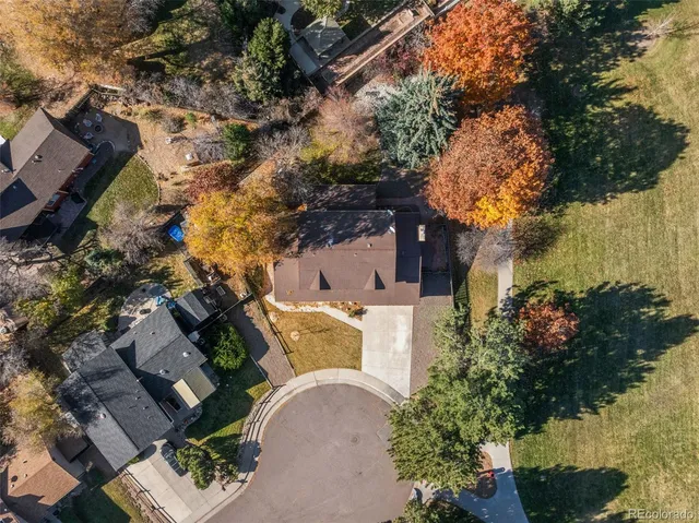 an aerial view of a house with a yard
