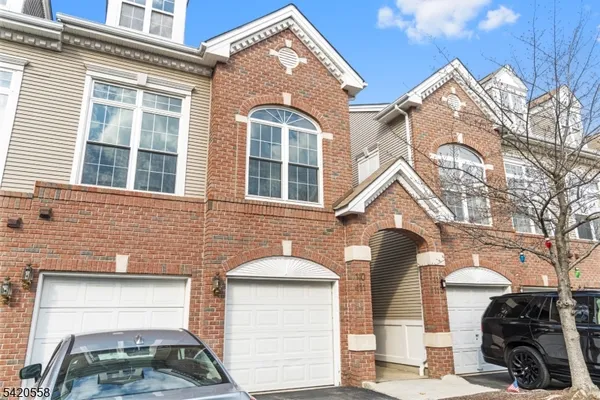 a front view of a house with parking space