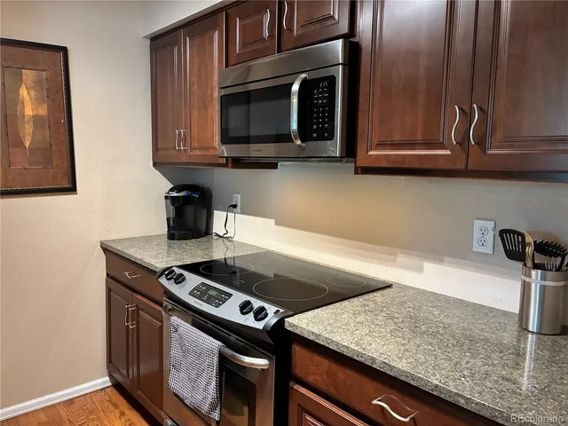 a kitchen with granite countertop a stove and a sink