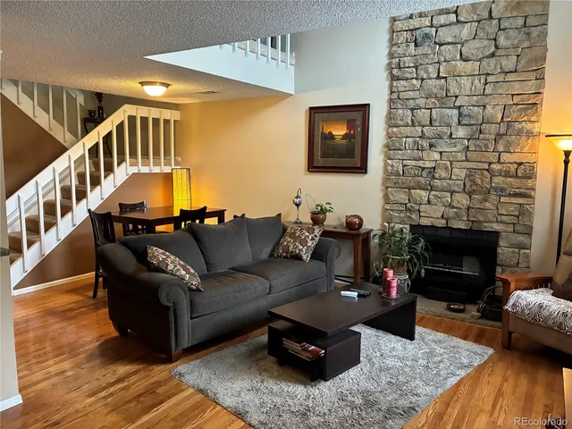 a living room with furniture and a fireplace