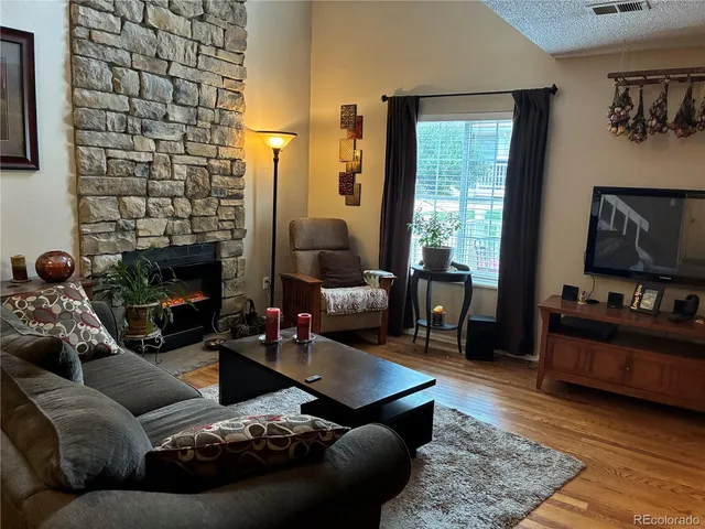 a living room with furniture and a fireplace