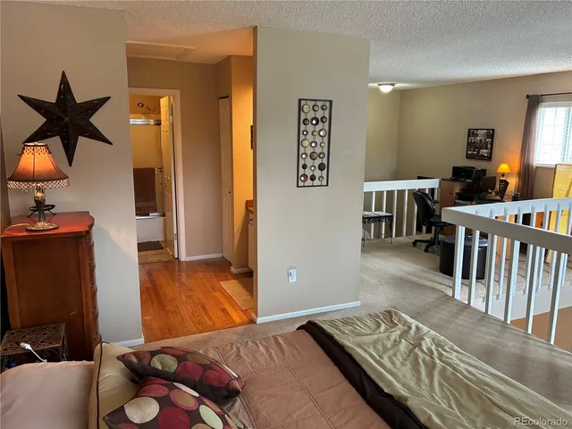 a bedroom with furniture and wooden floor