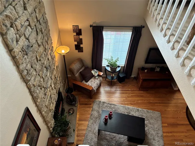 a view of living room with furniture and a fireplace
