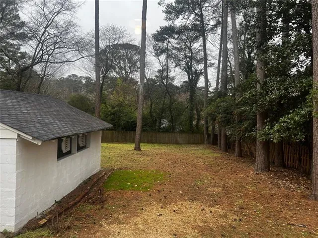 a backyard of a house with lots of trees