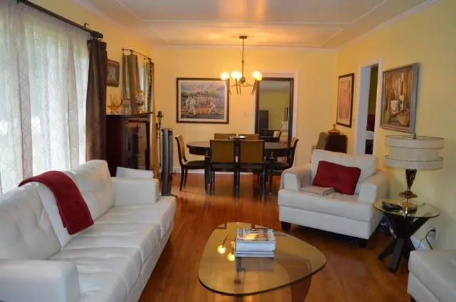 a living room with furniture and a chandelier