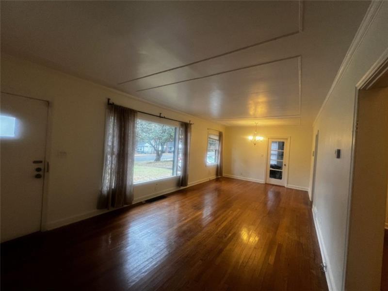 977 Lindridge Way Northeast Atlanta, GA 30324 - Photo 3 of 18 an empty room with wooden floor and windows