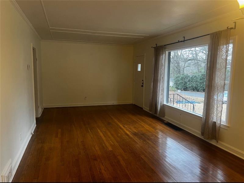 977 Lindridge Way Northeast Atlanta, GA 30324 - Photo 5 of 18 a view of a room with wooden floor and window