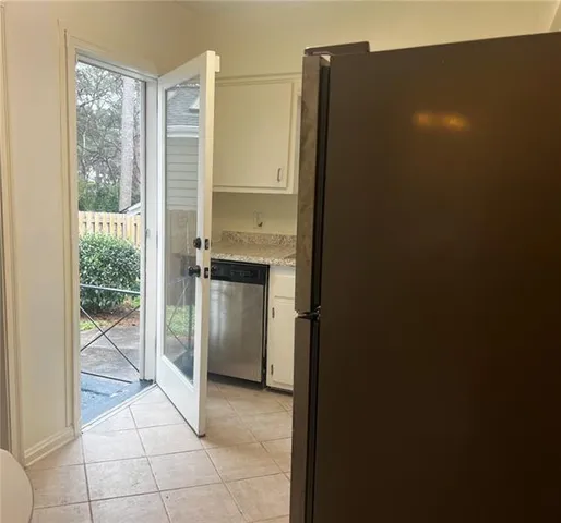 a kitchen with a refrigerator and window