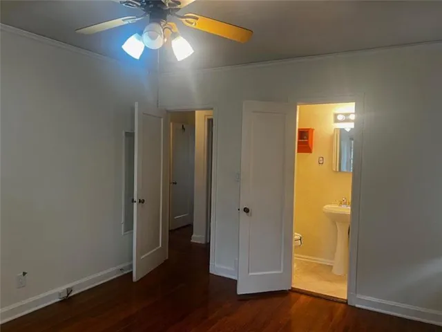 an empty room with wooden floor and door