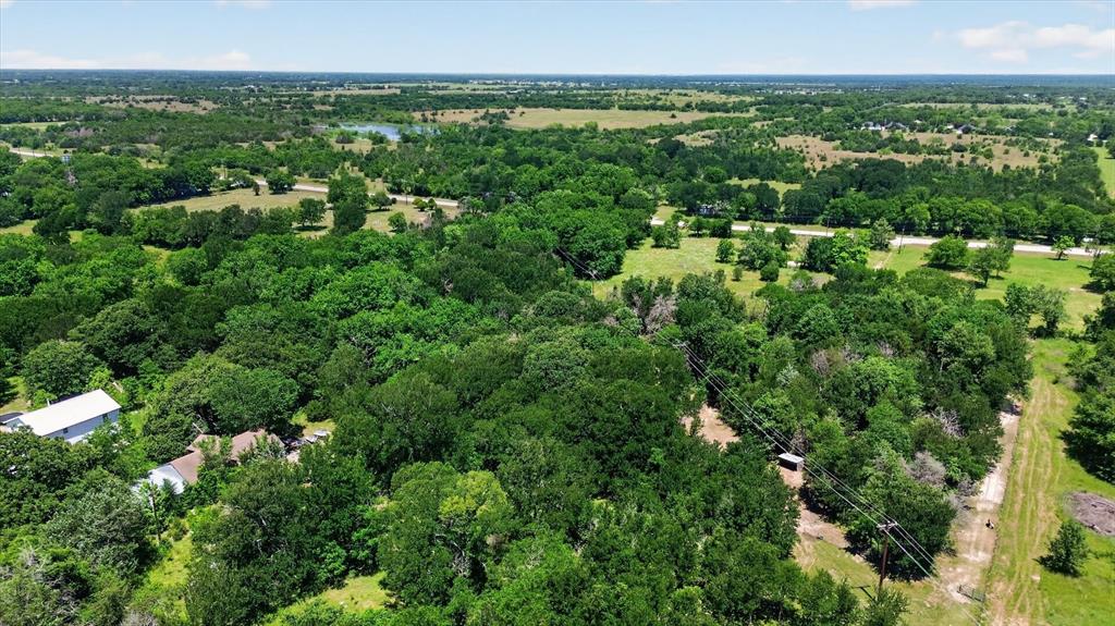 613 Main Street Quinlan, TX 75474 - Photo 6 of 16 Landscape featuring dense tree cover and open grassy areas