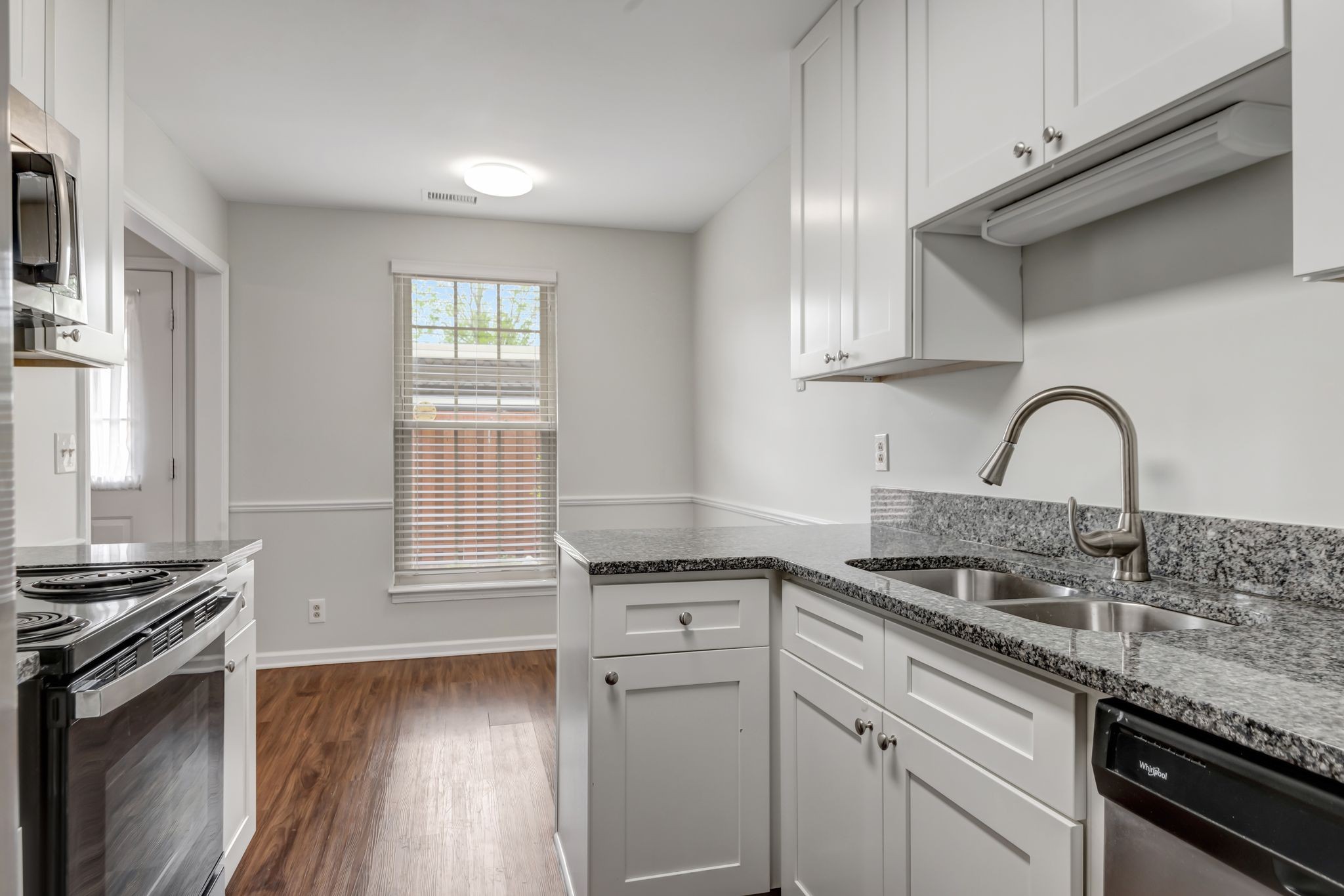 859 General George Patton Road Nashville, TN 37221 - Photo 18 of 34 a kitchen with granite countertop a sink stove and cabinets