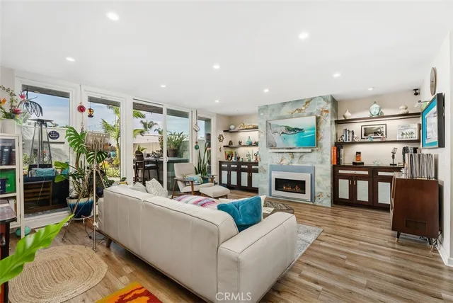 a living room with fireplace furniture and a flat screen tv