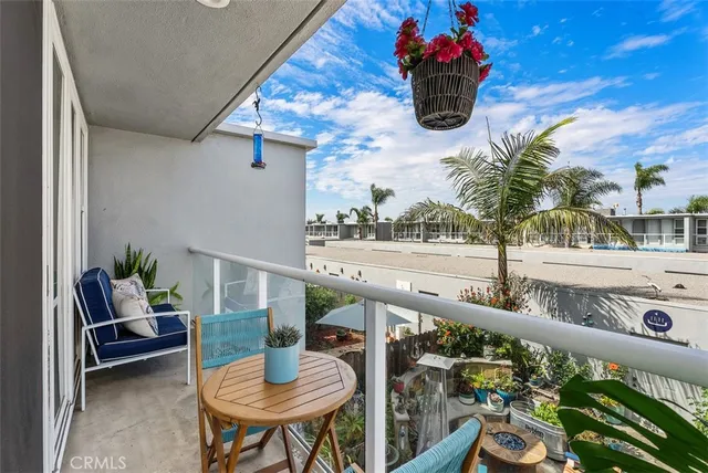 a view of a balcony and dining area with furniture