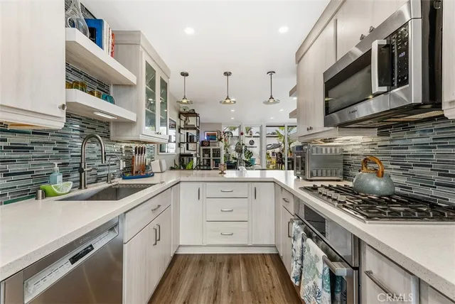 a kitchen with a sink stainless steel appliances and cabinets