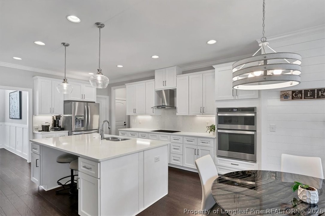 10 Heatherspring Way Spring Lake, NC 28390 - Photo 17 of 48 a kitchen with kitchen island a sink stainless steel appliances and a chandelier