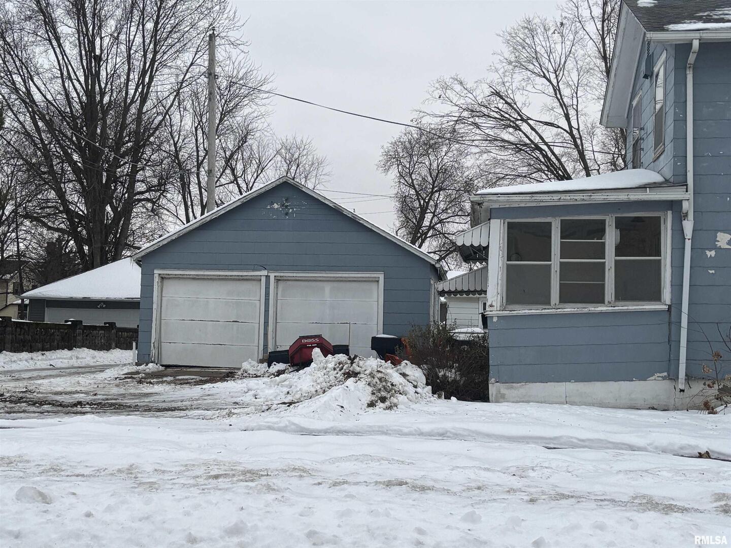 2231 Pershing Boulevard Clinton, IA 52732 - Photo 1 of 3 a front view of a house with a yard and garage