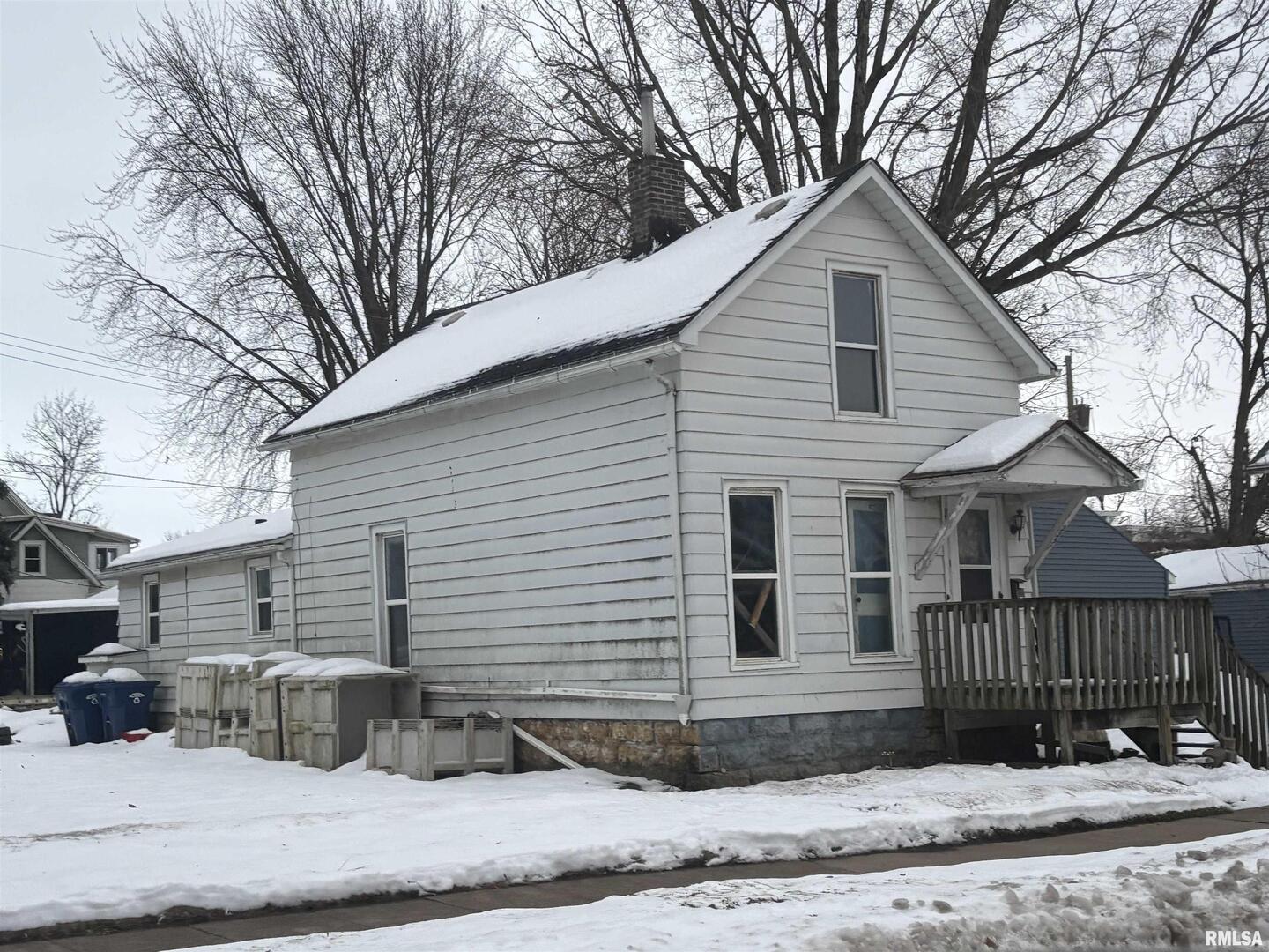 2231 Pershing Boulevard Clinton, IA 52732 - Photo 2 of 3 a view of a white house with a small yard and large tree