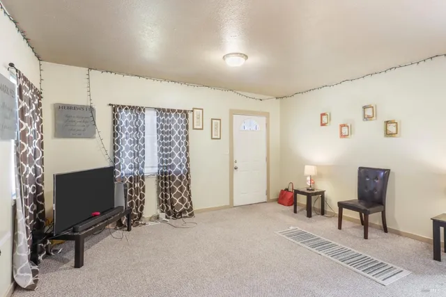 a view of a livingroom with furniture and a flat screen tv