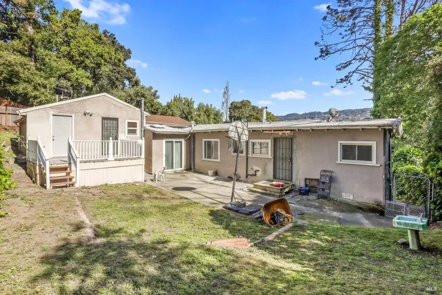 a view of a house with backyard porch and sitting area