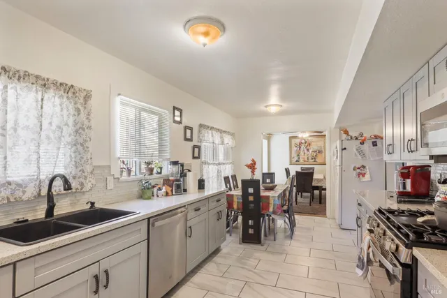 a kitchen with lots of counter top space and appliances