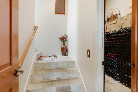 a kitchen with stainless steel appliances granite countertop a refrigerator a oven a sink with island and chairs