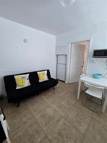 a living room with a bed and a table