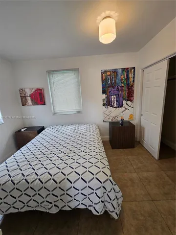 a bedroom with a bed and cabinets