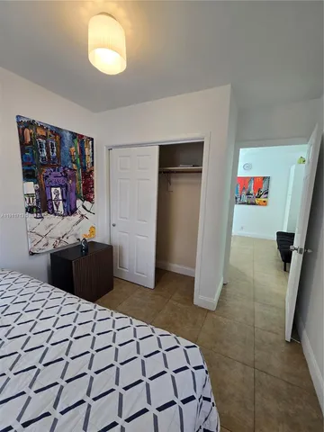 a bedroom with a bed and a mirror