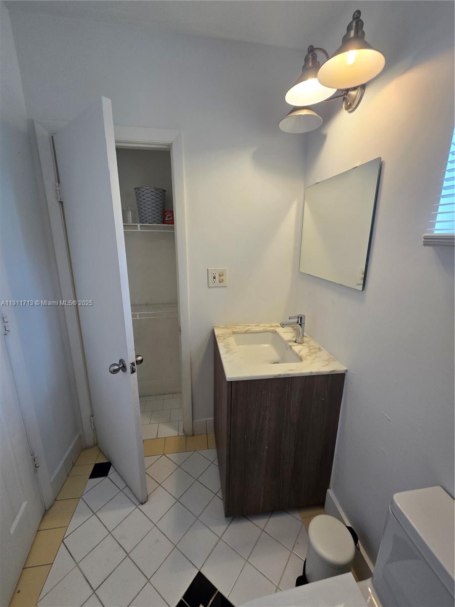 445 Northwest 125th Street, Unit 2 North Miami, FL 33168 - Photo 9 of 10 a bathroom with a sink vanity and toilet